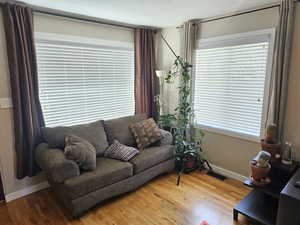 Living room with hardwood / wood-style flooring