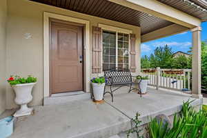 View of exterior entry featuring covered porch