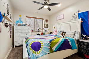 Bedroom featuring dark colored carpet and ceiling fan