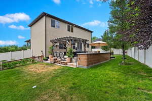 Rear view of property with a patio, a lawn, and a pergola