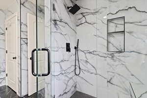 Bathroom with walk in shower and tile patterned flooring