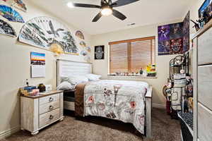 Carpeted bedroom with ceiling fan