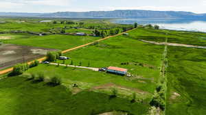 Birds eye view of property with a water and mountain view and a rural view