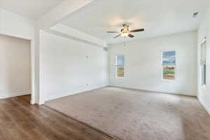 Carpeted spare room featuring ceiling fan