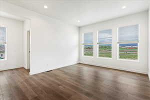 Unfurnished room with dark hardwood / wood-style floors