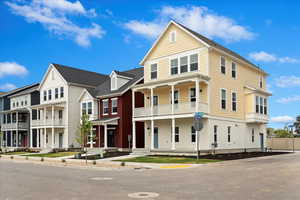 View of front of property with a balcony