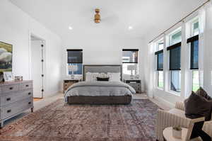 Bedroom featuring light carpet and ceiling fan