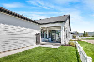 Rear view of property featuring a lawn