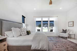 Carpeted bedroom with ceiling fan