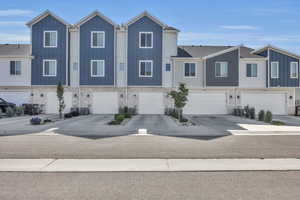 View of property featuring a garage and central AC