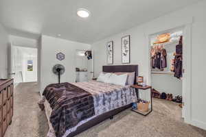 Carpeted bedroom featuring a closet