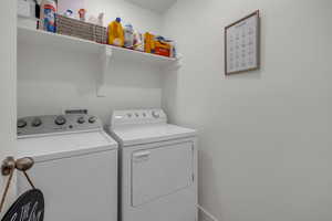 Clothes washing area featuring washer and dryer