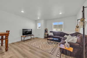 Living room with light hardwood / wood-style floors