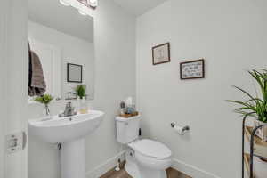 Bathroom featuring wood-type flooring and toilet