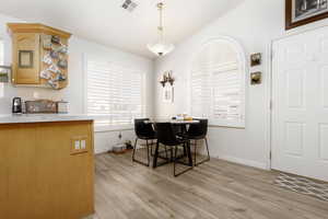 Dining area with light hardwood / wood-style floors