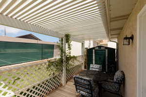 Deck featuring a storage shed