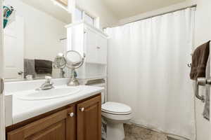 Bathroom featuring toilet and large vanity