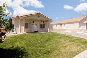 Mediterranean / spanish-style home featuring a front lawn and a garage