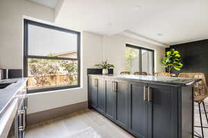 Kitchen featuring a kitchen bar, light hardwood / wood-style floors, and kitchen peninsula