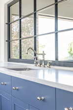 Interior details featuring blue cabinets and light stone countertops