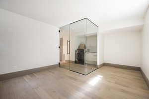 Unfurnished bedroom featuring a closet, light hardwood / wood-style flooring, and washer / clothes dryer