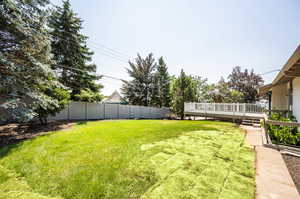 View of yard featuring a wooden deck