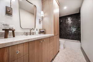 Full bathroom featuring tile floors, tiled shower / bath, toilet, and vanity