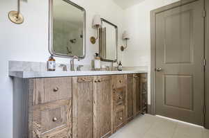 Bathroom with tile floors and dual vanity