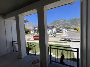 View of patio with a mountain view and a porch