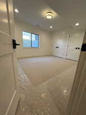 One of two large basement bedrooms, Interior space with light colored carpet