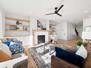 Living room with ceiling fan and light wood-type flooring