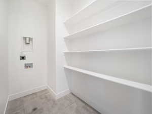 Laundry room featuring washer hookup, light tile patterned flooring, and electric dryer hookup