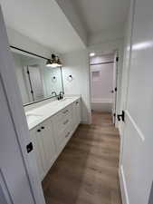 Bathroom featuring double vanity in the basement