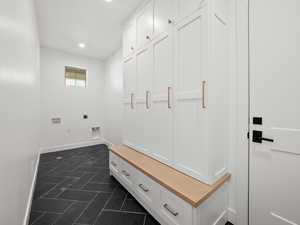 Mudroom with dark tile patterned floors