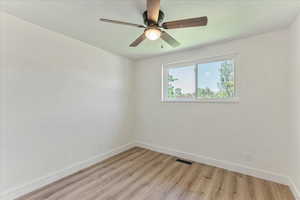 Spare room featuring ceiling fan and light wood-type flooring