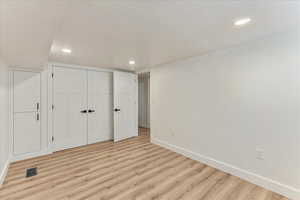 Unfurnished bedroom featuring a closet and light wood-type flooring