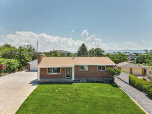 Ranch-style home with a front yard and central air condition unit