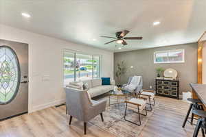 Living room featuring ceiling fan and light hardwood / wood-style flooring