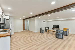 Living room with light hardwood / wood-style floors