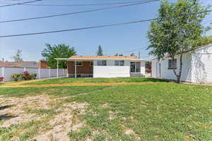 Rear view of property featuring a yard