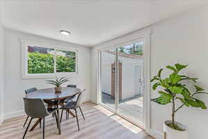 Dining area with light hardwood / wood-style flooring