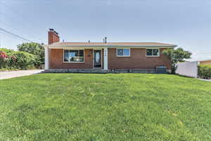 Ranch-style home with a front yard and central AC