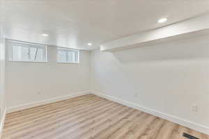 Basement featuring light hardwood / wood-style flooring