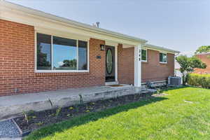 Ranch-style home with central AC and a front lawn