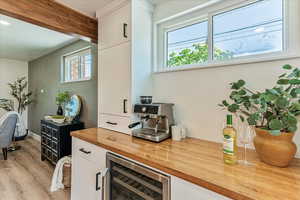 Interior space featuring wine cooler and light hardwood / wood-style floors