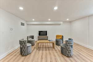 Sitting room with wood-type flooring