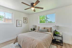 Bedroom with ceiling fan and hardwood / wood-style floors