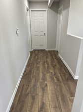 Hallway featuring dark wood-type flooring