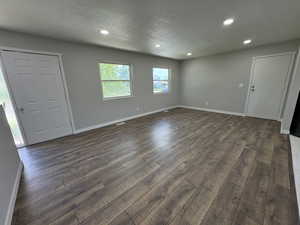 Interior space featuring a textured ceiling and dark hardwood / wood-style floors