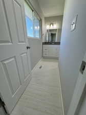 Bathroom featuring tile flooring, a textured ceiling, and vanity